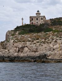 Building by sea against sky