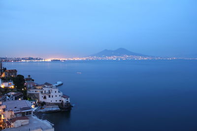 High angle view of city by sea against sky