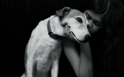 Dog looking away against black background