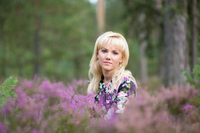 Young woman with yellow flowers on field