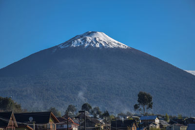 View on hornopirén volcano with roofs of small hornopirén town