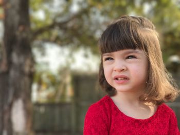 Close-up of cute girl against trees