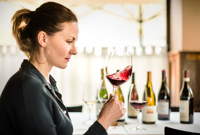 Side view of a woman drinking glass