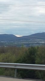 Scenic view of mountains against cloudy sky