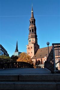 View of buildings against clear blue sky