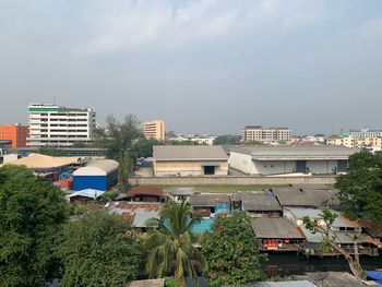 High angle view of buildings in city against sky