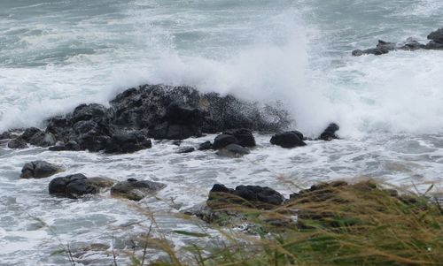 Waves breaking against sea