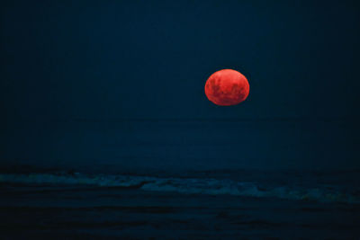 View of sea against moon at night