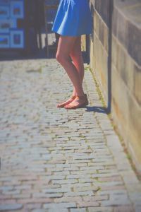 Low section of woman standing on tiled floor
