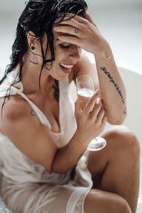 Midsection of a beautiful young woman drinking glass
