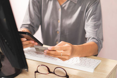 Midsection of businessman working at office