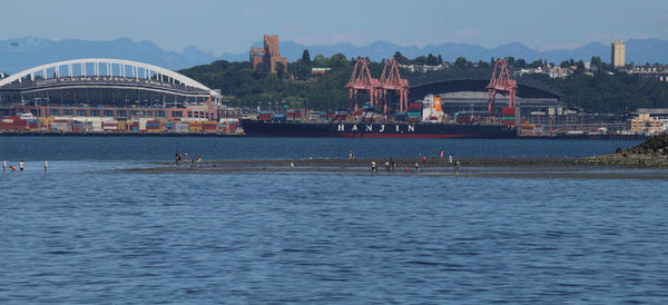 View of buildings by sea against sky