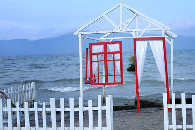 Lifeguard hut on beach against sky