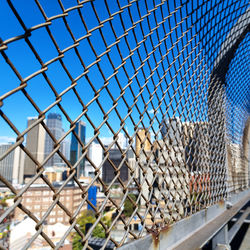 Chainlink fence against blue sky