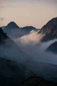 Scenic view of pyrenees against sky during foggy weather