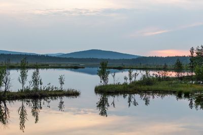 Scenic view of lake against sky during sunset