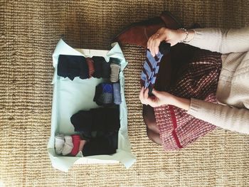 High angle view of woman folding socks