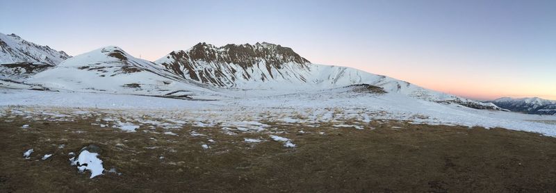 Scenic view of snowcapped mountains against clear sky