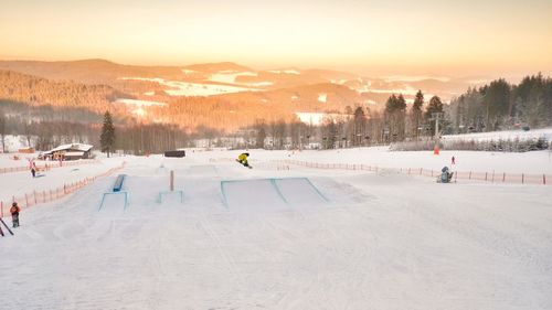 People skiing on snow covered landscape