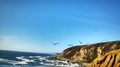 Scenic view of sea against clear blue sky