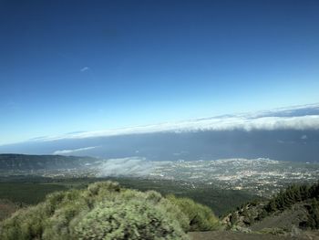 Scenic view of mountains against blue sky