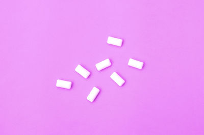 High angle view of pink art on purple background