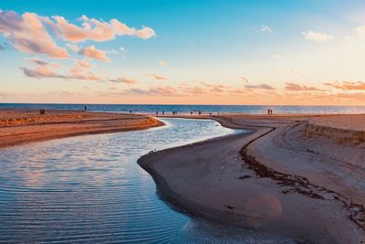 Scenic view of beach against sky during sunset