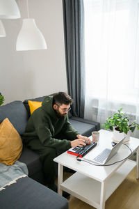 Woman using laptop at home