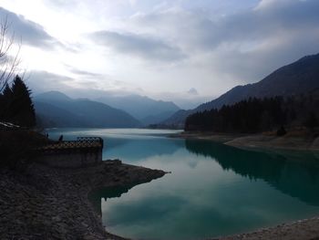 Scenic view of lake and mountains against sky