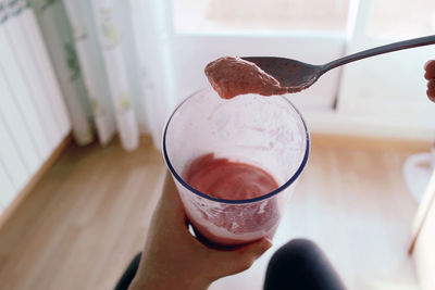 Close-up of woman having smoothie