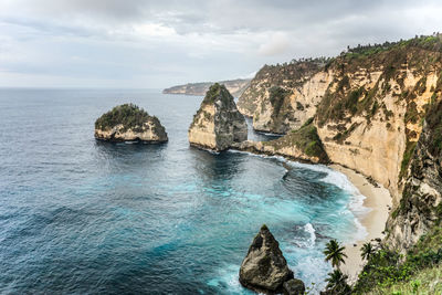 Panoramic view of rocks in sea against sky