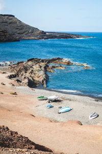 Boats parked on the volcanic coast of the island of lanzarote - canary islands