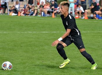 Full length of man playing soccer on field