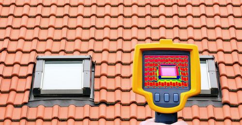 Close-up of smart phone against brick wall