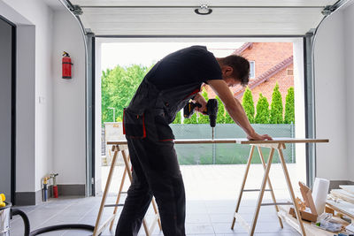 Side view of young man working at home