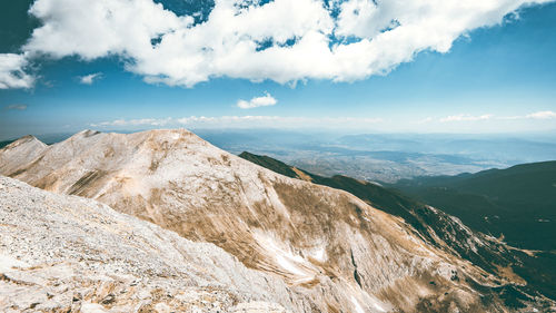 Scenic view of mountains against cloudy sky