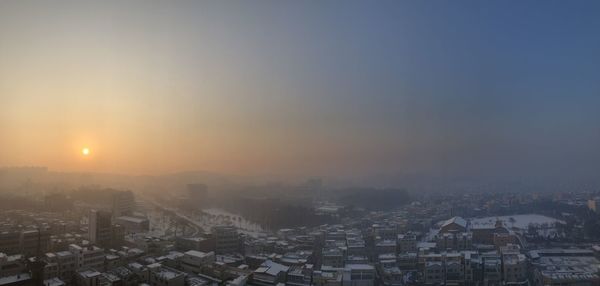 Cityscape against clear sky during sunset