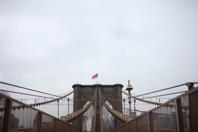 Low angle view of suspension bridge against sky