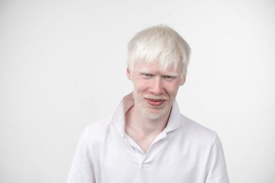 Portrait of smiling man against white background