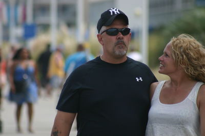 Man and woman wearing sunglasses outdoors