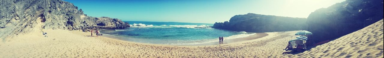 beach, sea, water, sand, shore, scenics, beauty in nature, nature, blue, sunlight, tranquility, tranquil scene, surf, wave, vacations, clear sky, horizon over water, mountain, idyllic, day