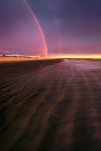 Scenic view of beach against sky during sunset