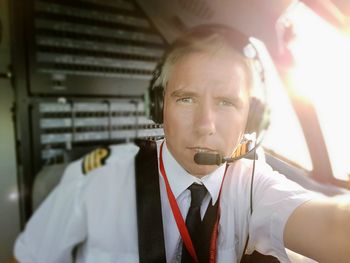 Portrait of pilot holding camera