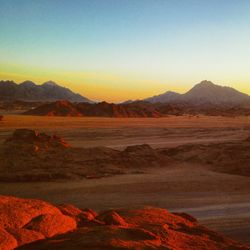 Scenic view of desert against sky during sunset