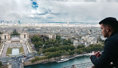 Man and river against buildings in city