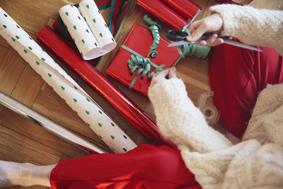 Woman's hands packing christmas presents