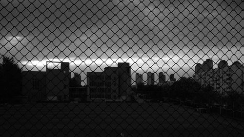 Close-up of chainlink fence against sky