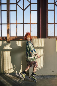 Woman standing by window