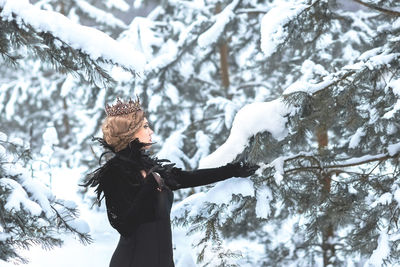 Low angle view of woman standing on snow