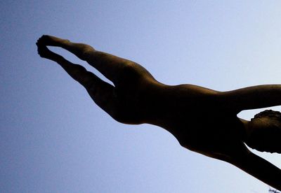 Close-up of hand against clear blue sky